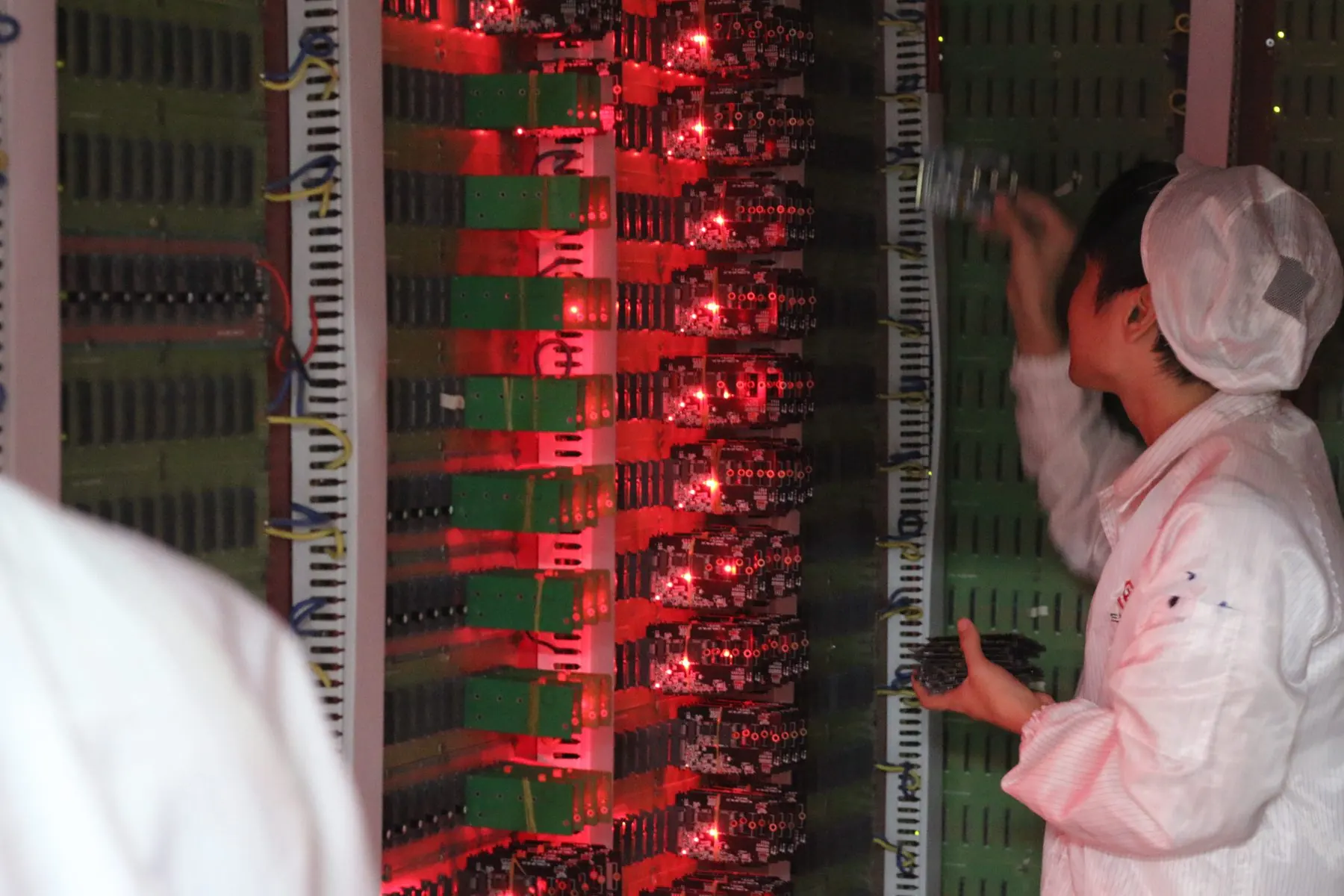MRYK PCBA ageing test chamber — cleanroom engineer inspecting boards under red LEDs
